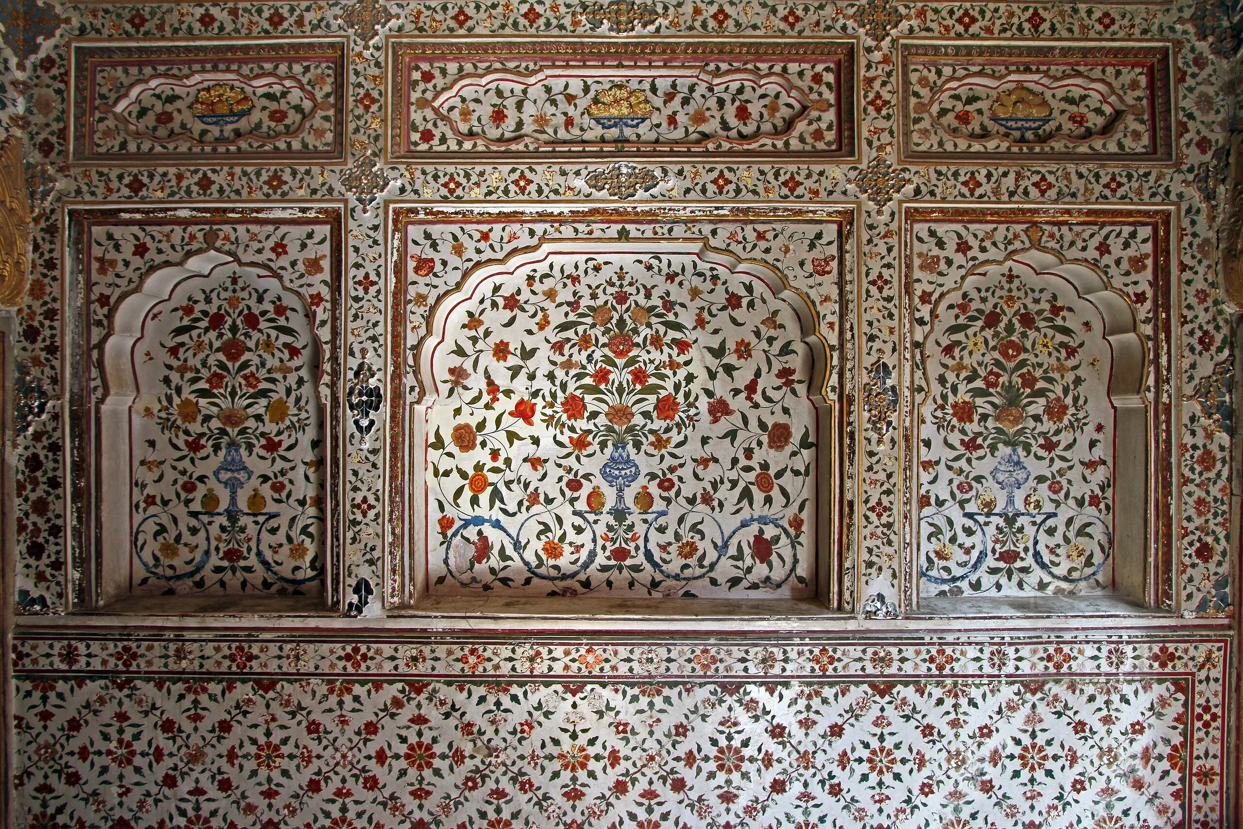 Painted floral niches and ornamented wall panels with vases and fruit bowls inside Junagarh Fort, Bikaner