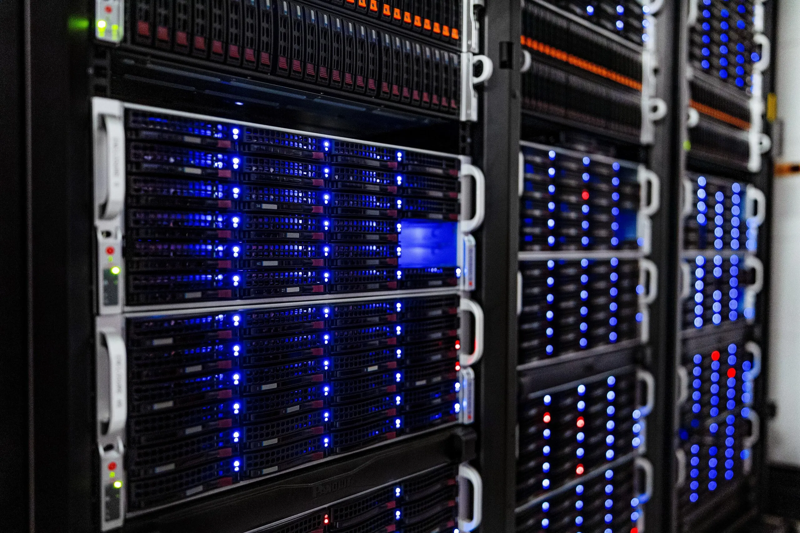 Rack-mounted servers with blue status LEDs in the NOIRLab headquarters computer server room, Tucson, Arizona